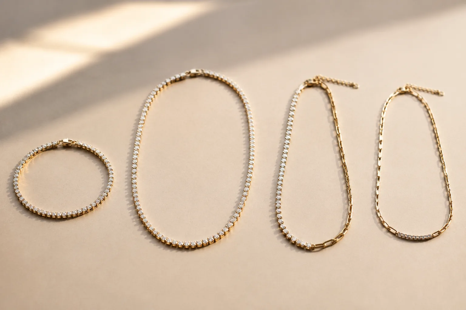 Different unbranded tennis-style bracelet and necklace formats shown on a neutral surface.
