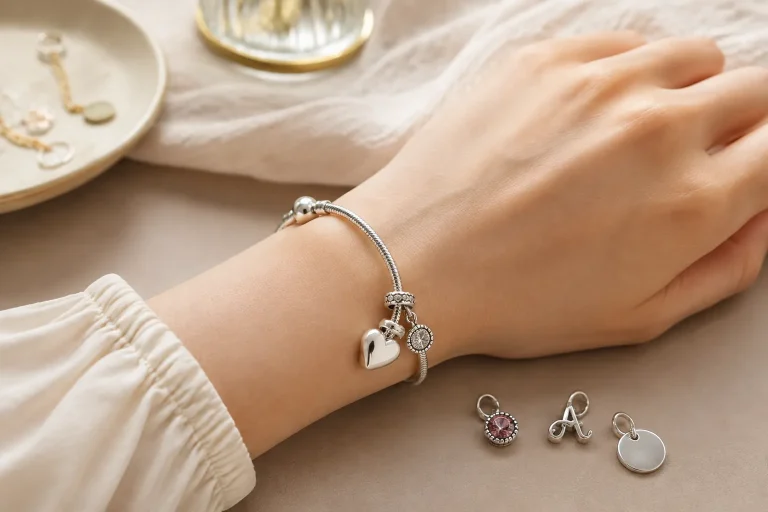 How to Choose a Charm Bracelet That Can Grow Over Time A lightly filled silver charm bracelet on an adult wrist shows how leaving space on the bracelet helps future charms fit comfortably over time.